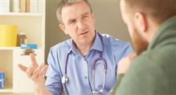 healthcare professional with stethoscope around his neck talking to patient in office