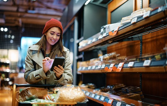 woman grocery shopping with mobile phone