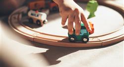 Kid playing with train on track