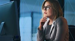 Woman studying computer screen