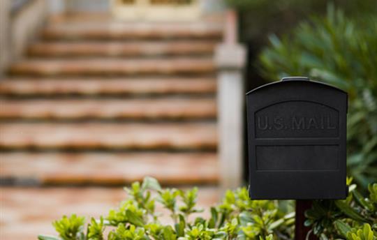 black mailbox in front of porch steps