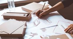 Designer draws a mockup for crafting cardboard box.