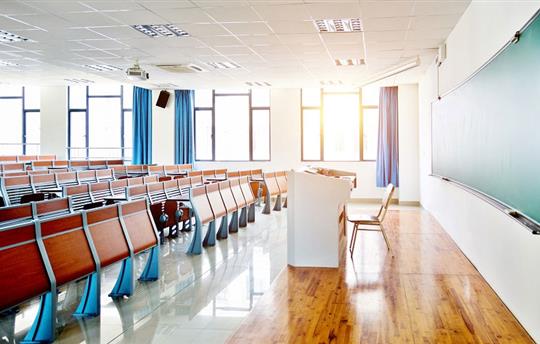empty, sunlit lecture hall at a university