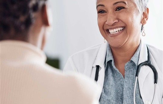 senior woman doctor smiling at patient