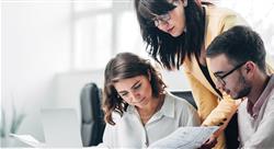 three supply chain coworkers reviewing print and digital communications