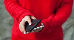 Person in red sweater putting protective case on smartphone
