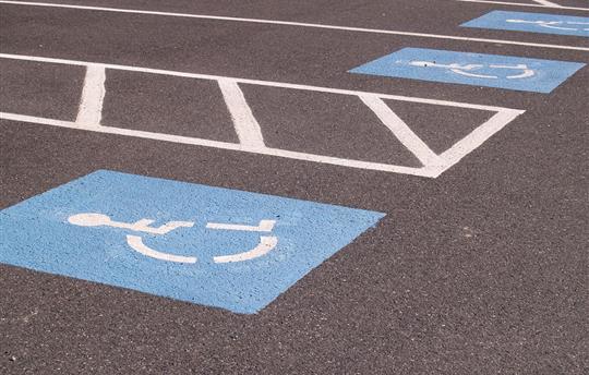 Blue handicap parking markers in parking lot spaces