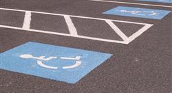 Blue handicap parking markers in parking lot spaces