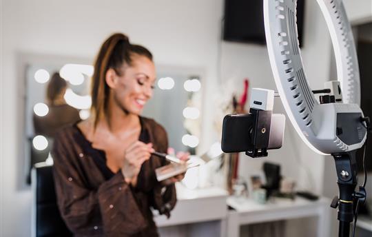 beauty influencer holding makeup