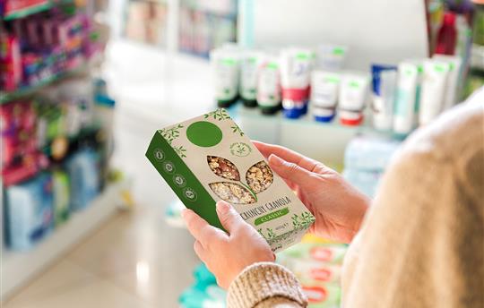 consumer holding a box of granola