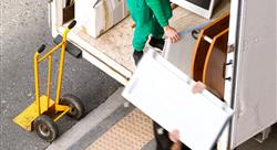 Two movers taking furniture out of a moving truck