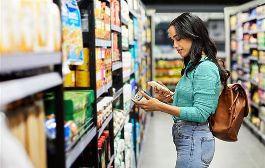 woman scanning the barcode of a soup can with her phone